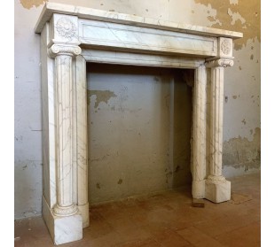 Antique original Louis XVI fireplace mantel, with fluted columns, carved in white veined Carrara marble.