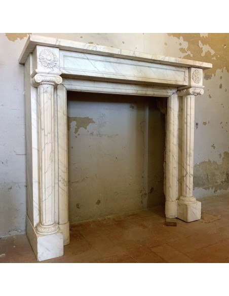 Antique original Louis XVI fireplace mantel, with fluted columns, carved in white veined Carrara marble.
