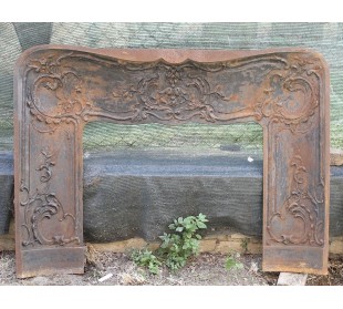 Large baroque cast iron insert, artistically crafted, that can be adapted to fit the mantel of a marble fireplace.