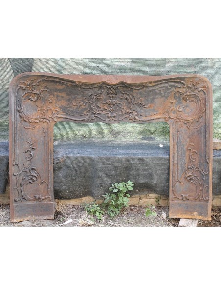 Large baroque cast iron insert, artistically crafted, that can be adapted to fit the mantel of a marble fireplace.