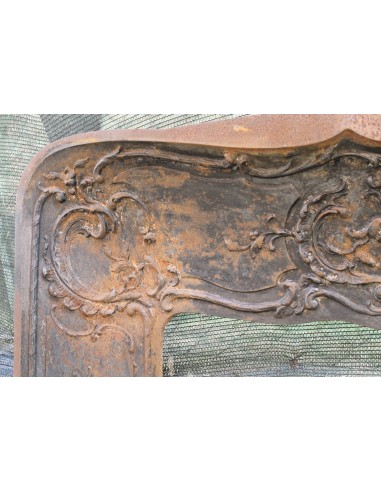 Large baroque cast iron insert, artistically crafted, that can be adapted to fit the mantel of a marble fireplace.