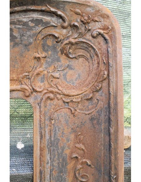 Large baroque cast iron insert, artistically crafted, that can be adapted to fit the mantel of a marble fireplace.