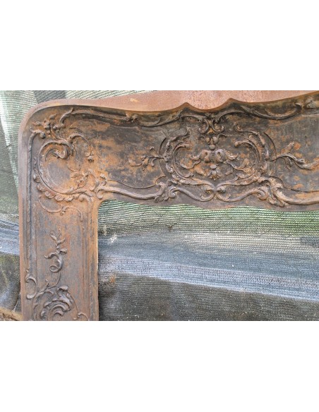 Large baroque cast iron insert, artistically crafted, that can be adapted to fit the mantel of a marble fireplace.