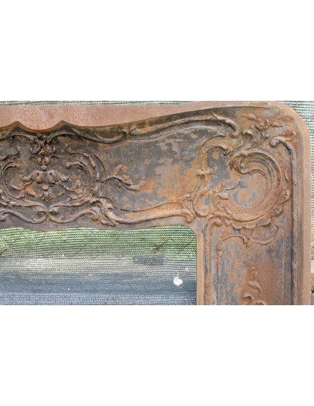 Large baroque cast iron insert, artistically crafted, that can be adapted to fit the mantel of a marble fireplace.