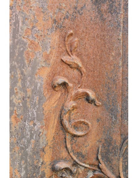 Large baroque cast iron insert, artistically crafted, that can be adapted to fit the mantel of a marble fireplace.