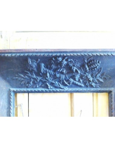 Antique cast iron insert, artistically crafted, designed to fit the opening of a marble fireplace mantel.