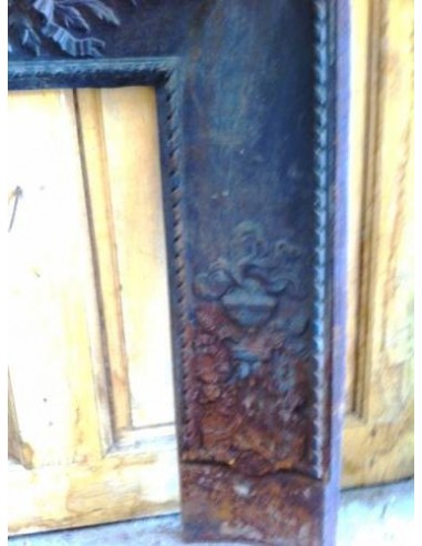 Antique cast iron insert, artistically crafted, designed to fit the opening of a marble fireplace mantel.