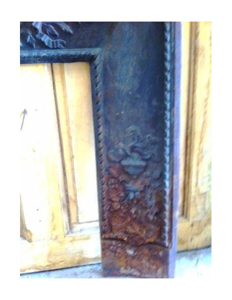Antique cast iron insert, artistically crafted, designed to fit the opening of a marble fireplace mantel.