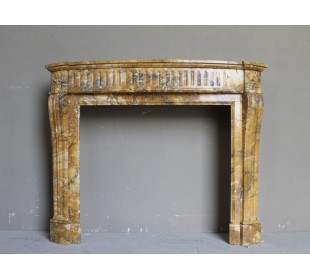 Antique Louis XVI fireplace mantel carved in Yellow marble. This Giallo Siena marble comes from Italy.