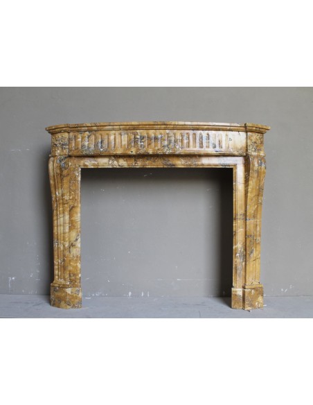 Antique Louis XVI fireplace mantel carved in Yellow marble. This Giallo Siena marble comes from Italy.