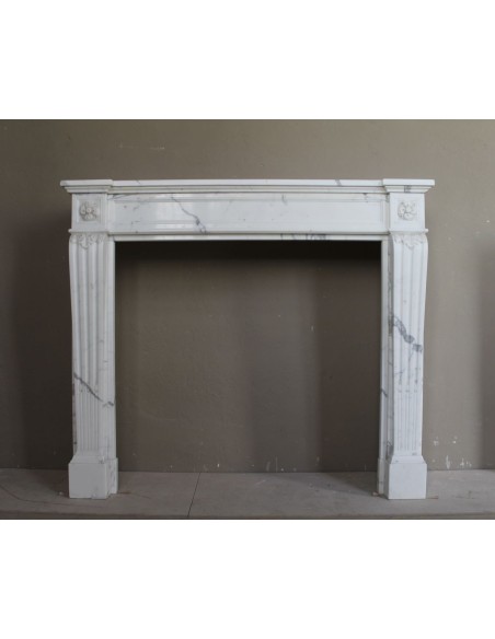 Antique Neoclassical marble mantel carved in White Calacatta with floral carving.