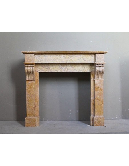 Antique original Louis Philippe Modillon fireplace mantel carved in yellow marble. This fire surround is at a very low price.