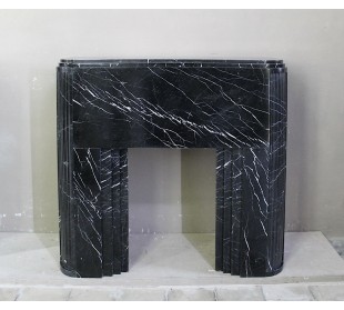 ICONIC ART DECO FIREPLACE MANTEL CARVED FROM BLACK MARQUINIA MARBLE. A ONE-OF-A-KIND MARBLE FIRE SURROUND.
