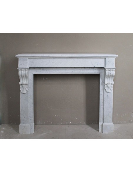 Antique fireplace carved in white Carrara marble called “Palmettes” with sober and elegant lines.