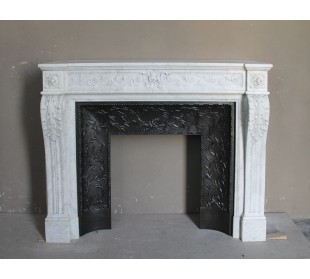 Antique Neoclassical white marble fireplace with floral decorations and “snail” elements, with its original cast iron insert.