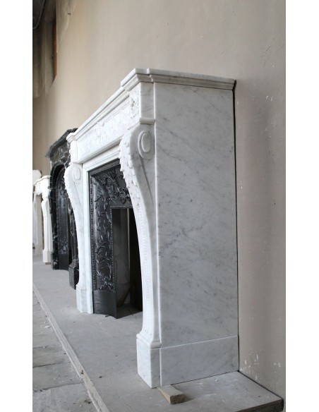 251 AG NEOCLASSICAL "ESCARGOT" FIREPLACE MANTEL CARVED OUT OF WHITE CARRARA MARBLE PROVIDED WITH ITS ORIGINAL CAST IRON INSERT