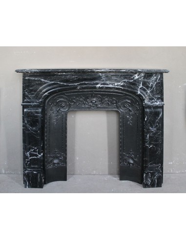 Antique fireplace carved out of black Marquinia marble, with white veins, elegant and impressive.