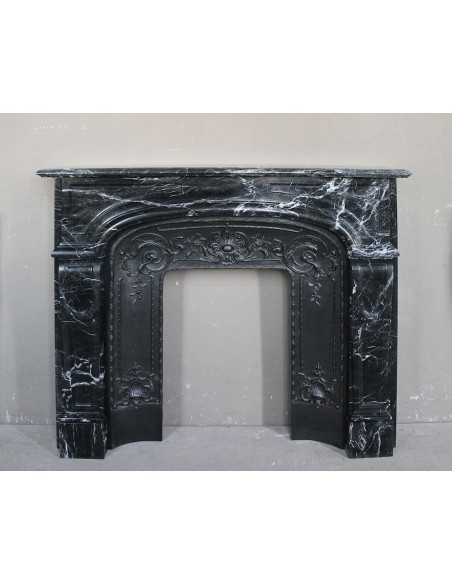 Antique fireplace carved out of black Marquinia marble, with white veins, elegant and impressive.