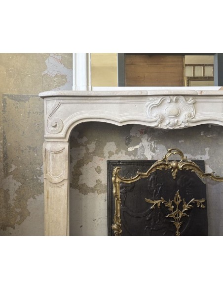 Antique baroque-style fireplace mantel carved in Beaujolais stone.