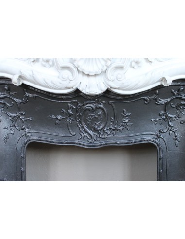 Exceptional antique Baroque fireplace mantel in white marble with floral carvings and its original cast iron insert.