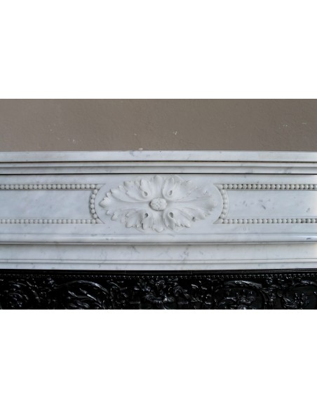Antique Louis XVI "Trois Fleurs Perlé" fireplace mantel in white Carrara marble, with its original elegant cast iron insert.