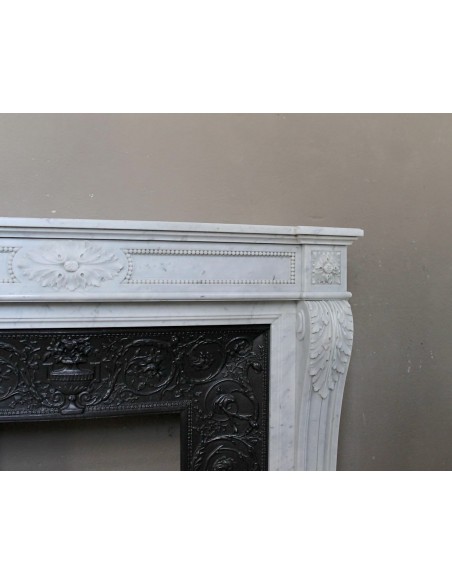 Antique Louis XVI "Trois Fleurs Perlé" fireplace mantel in white Carrara marble, with its original elegant cast iron insert.