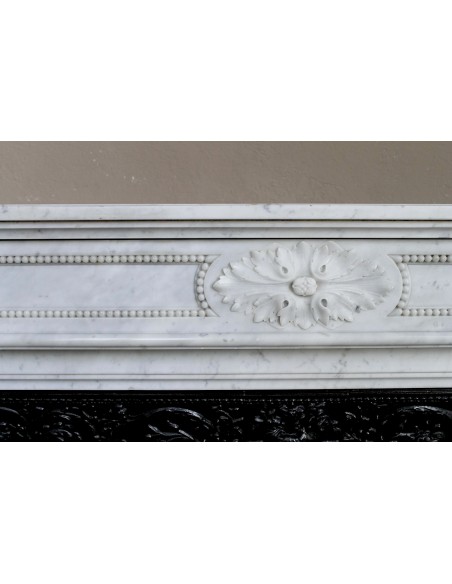 Antique Louis XVI "Trois Fleurs Perlé" fireplace mantel in white Carrara marble, with its original elegant cast iron insert.