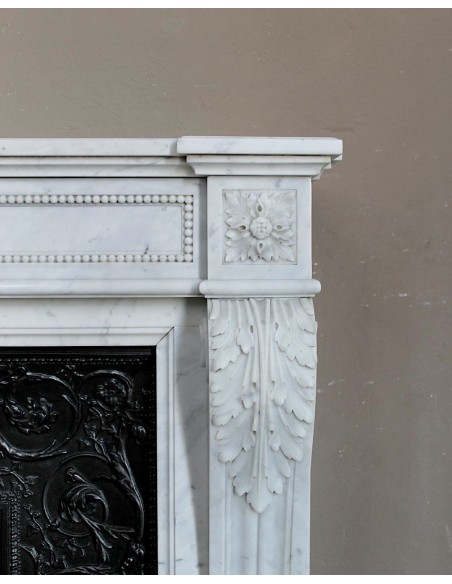 Antique Louis XVI "Trois Fleurs Perlé" fireplace mantel in white Carrara marble, with its original elegant cast iron insert.