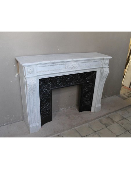 Antique Louis XVI "Trois Fleurs Perlé" fireplace mantel in white Carrara marble, with its original elegant cast iron insert.