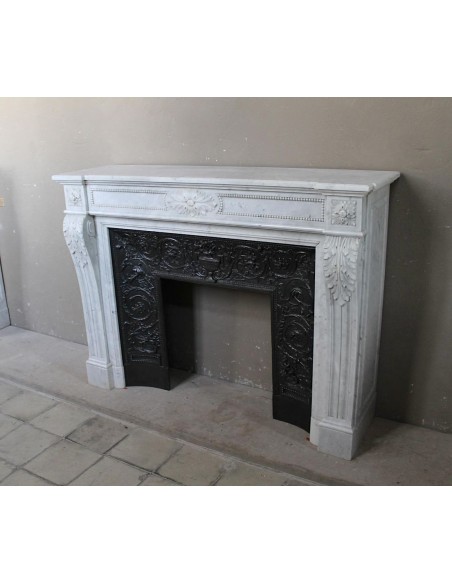 Antique Louis XVI "Trois Fleurs Perlé" fireplace mantel in white Carrara marble, with its original elegant cast iron insert.
