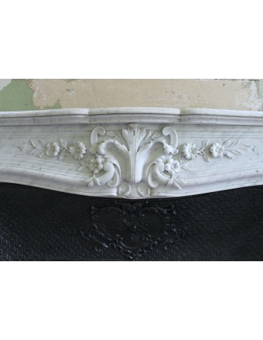 Wonderful fireplace mantel with floral carvings in white Carrara marble. This fireplace is signed by Majorelle.