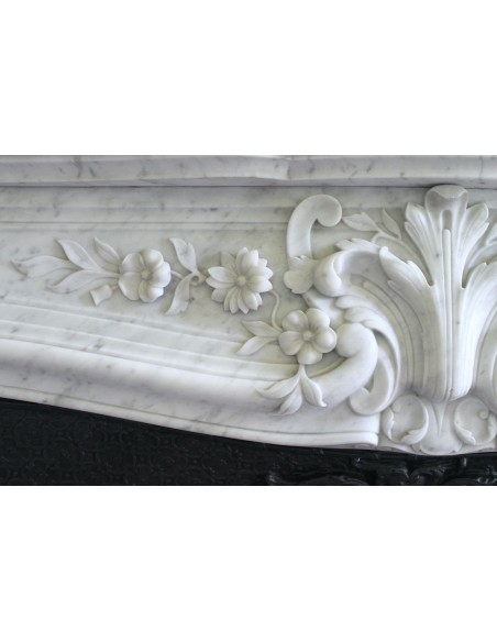 Wonderful fireplace mantel with floral carvings in white Carrara marble. This fireplace is signed by Majorelle.