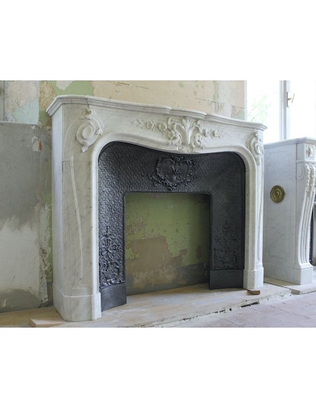 Wonderful fireplace mantel with floral carvings in white Carrara marble. This fireplace is signed by Majorelle.