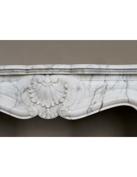 Antique Louis XV "Trois Coquilles Amélioré" fireplace mantel carved in veined White Calacatta marble. A rare and elegant mantel.