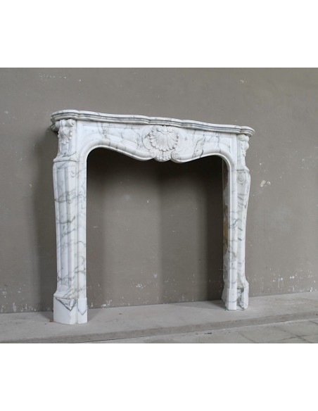 Antique Louis XV "Trois Coquilles Amélioré" fireplace mantel carved in veined White Calacatta marble. A rare and elegant mantel.
