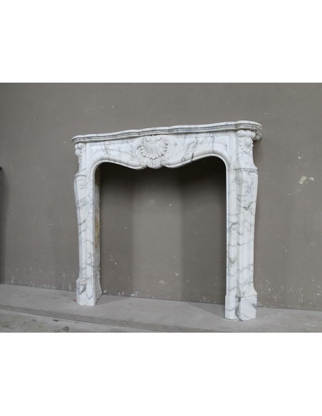 Antique Louis XV "Trois Coquilles Amélioré" fireplace mantel carved in veined White Calacatta marble. A rare and elegant mantel.