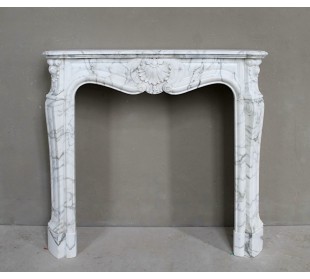 Antique Louis XV "Trois Coquilles Amélioré" fireplace mantel carved in veined White Calacatta marble. A rare and elegant mantel.