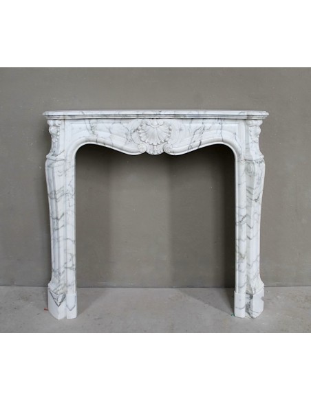 Antique Louis XV "Trois Coquilles Amélioré" fireplace mantel carved in veined White Calacatta marble. A rare and elegant mantel.