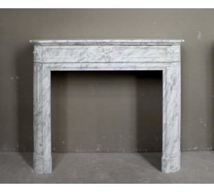 Neoclassical fire surround in Statuary Arabescato marble featuring soft gray veins on a white background.