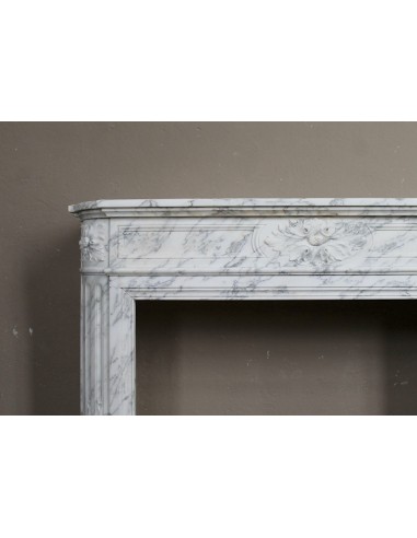Neoclassical fire surround in Statuary Arabescato marble featuring soft gray veins on a white background.