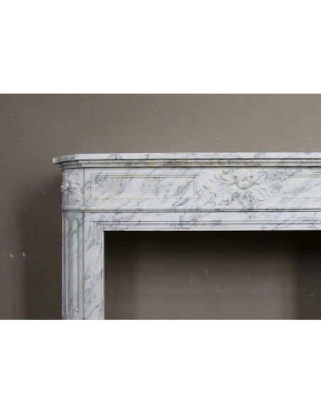 Neoclassical fire surround in Statuary Arabescato marble featuring soft gray veins on a white background.