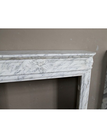 Neoclassical fire surround in Statuary Arabescato marble featuring soft gray veins on a white background.