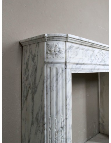 Neoclassical fire surround in Statuary Arabescato marble featuring soft gray veins on a white background.