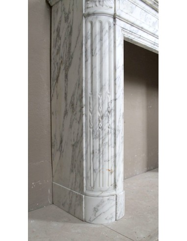 Neoclassical fire surround in Statuary Arabescato marble featuring soft gray veins on a white background.