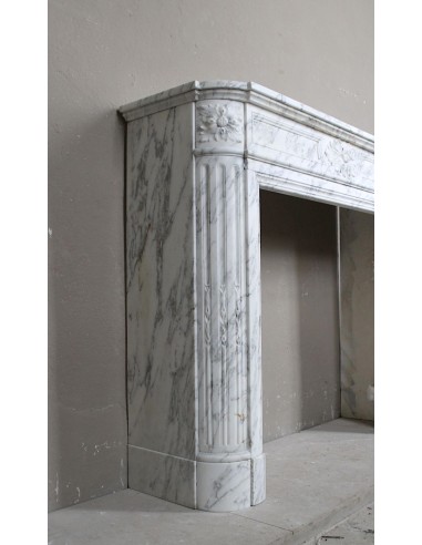 Neoclassical fire surround in Statuary Arabescato marble featuring soft gray veins on a white background.