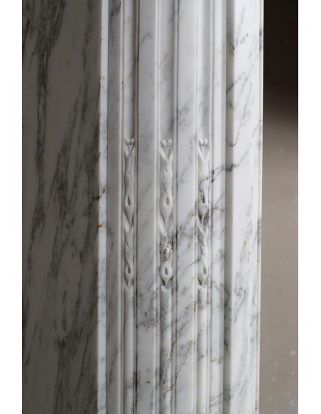 Neoclassical fire surround in Statuary Arabescato marble featuring soft gray veins on a white background.