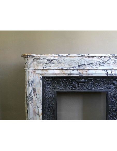 Exceptional antique Neoclassical-style fireplace mantel with fine floral carvings in stunning Italian Calacatta Gold marble.