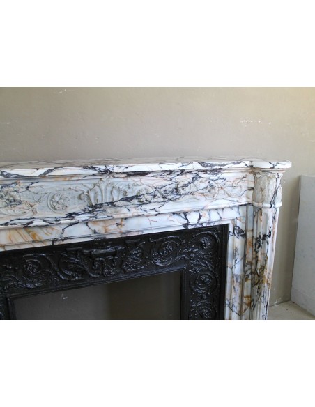 Exceptional antique Neoclassical-style fireplace mantel with fine floral carvings in stunning Italian Calacatta Gold marble.