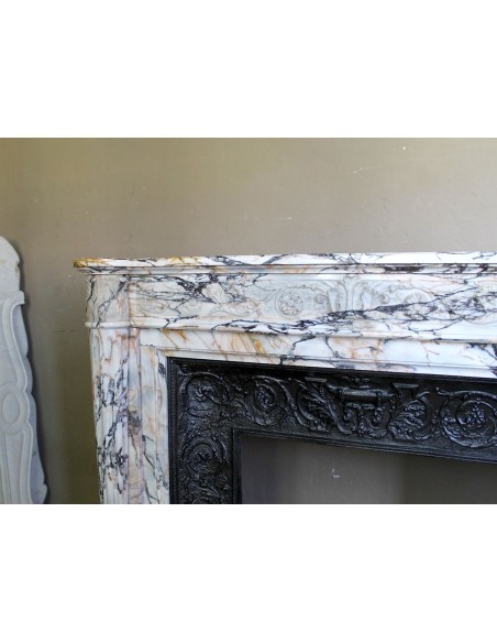 Exceptional antique Neoclassical-style fireplace mantel with fine floral carvings in stunning Italian Calacatta Gold marble.