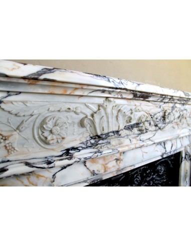 Exceptional antique Neoclassical-style fireplace mantel with fine floral carvings in stunning Italian Calacatta Gold marble.